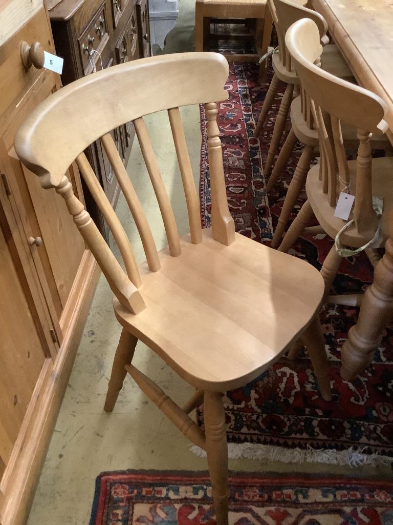 A Victorian style rectangular pine kitchen table, length 180cm, width 86cm, height 77cm and four beech Windsor kitchen chairs